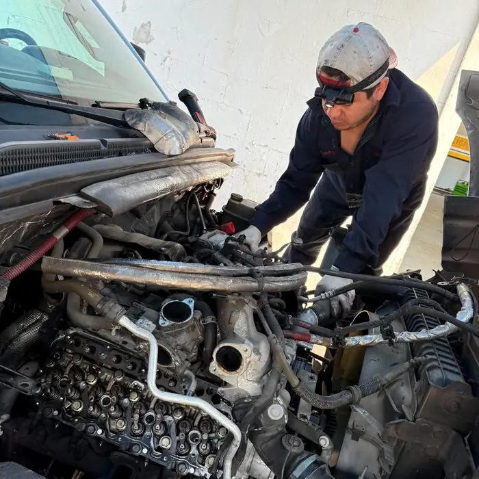 Technician rebuilding a diesel engine