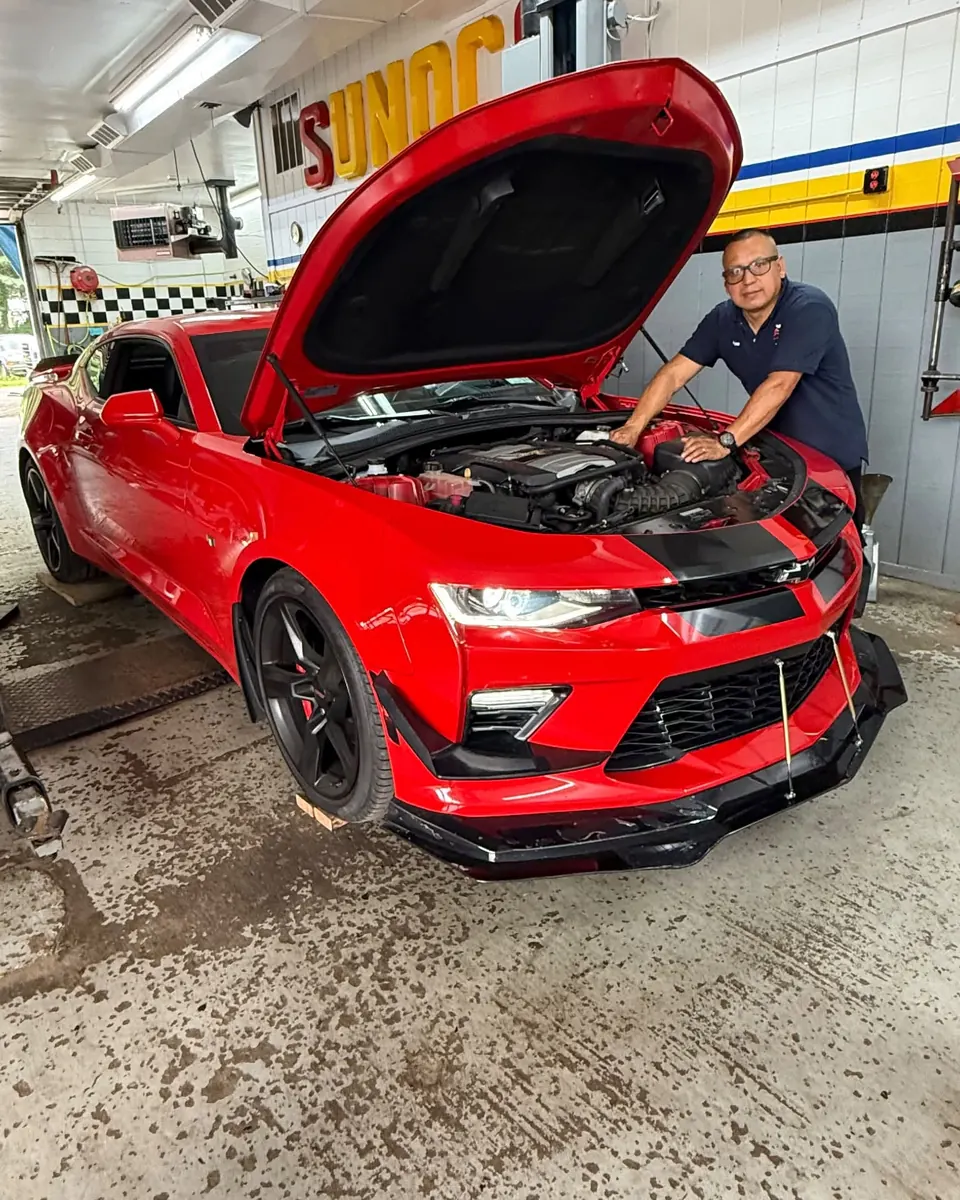 Victor, owner of AA Auto Tech Center, with a Camaro SS in the shop