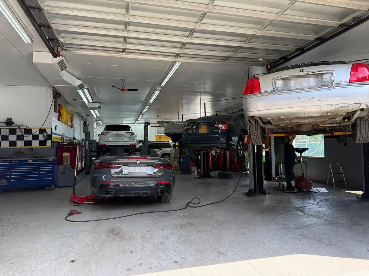 Cars on the lifts inside AA Auto Tech Center